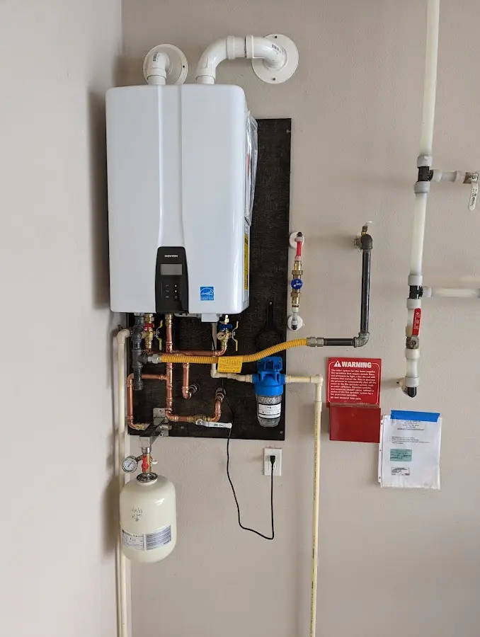 Professional plumber installing copper piping in a Port Clinton home